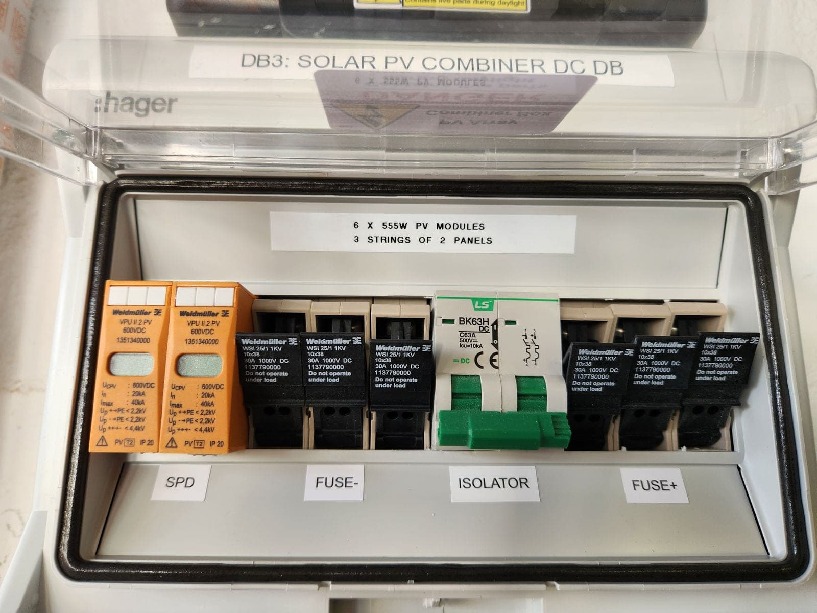 PV combiner enclosure open, showing string protection and labelling