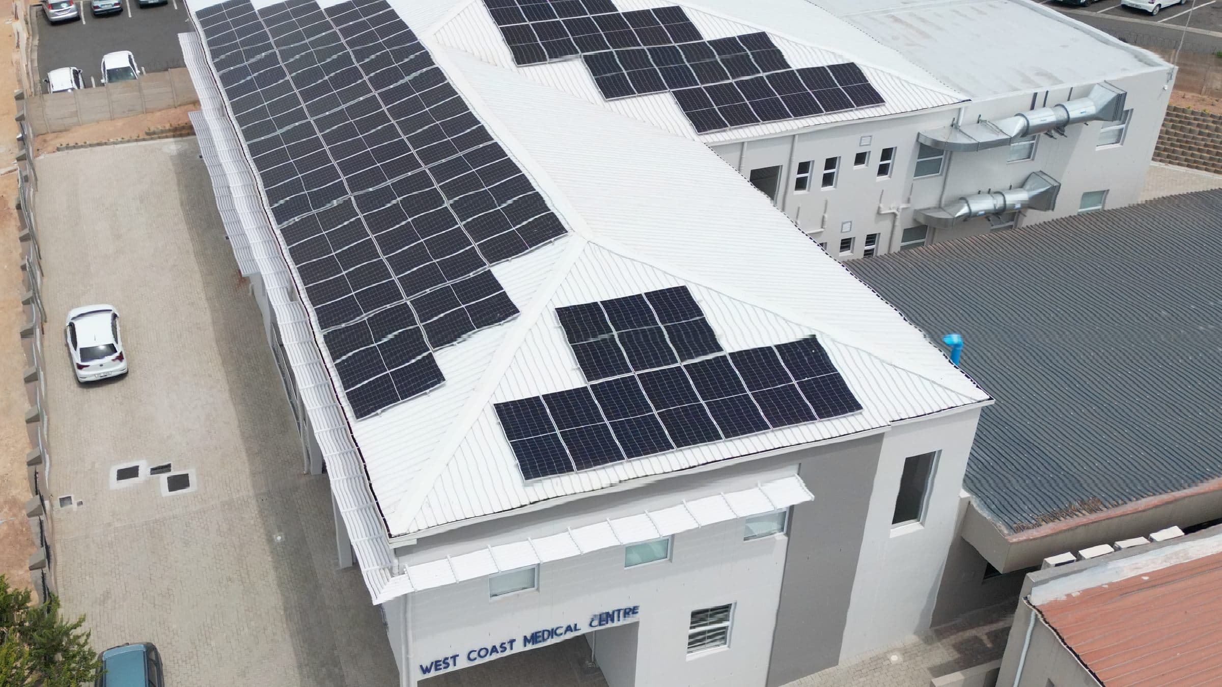 Aerial view of a West Coast medical centre with a roof-mounted solar array