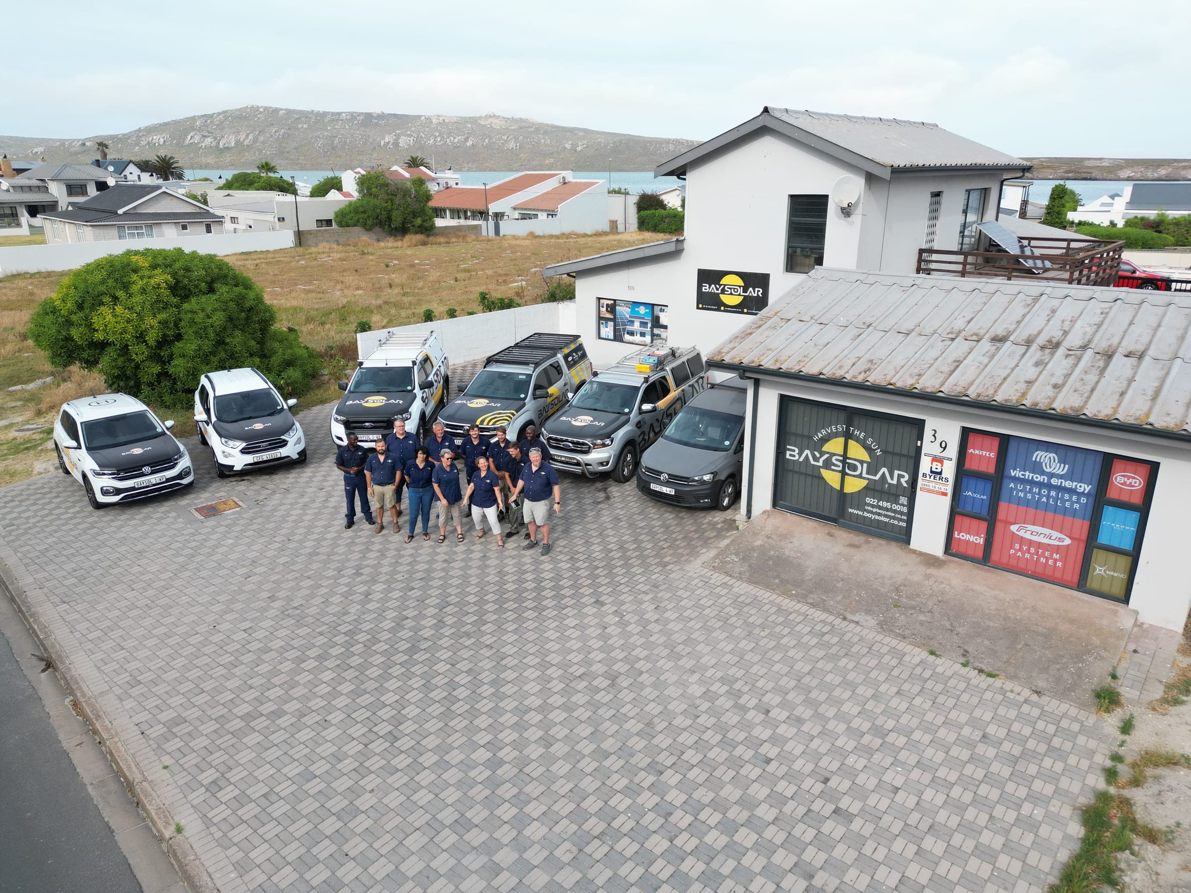 Aerial view of the Bay Solar premises, team and branded fleet at 39 Main Street, Langebaan