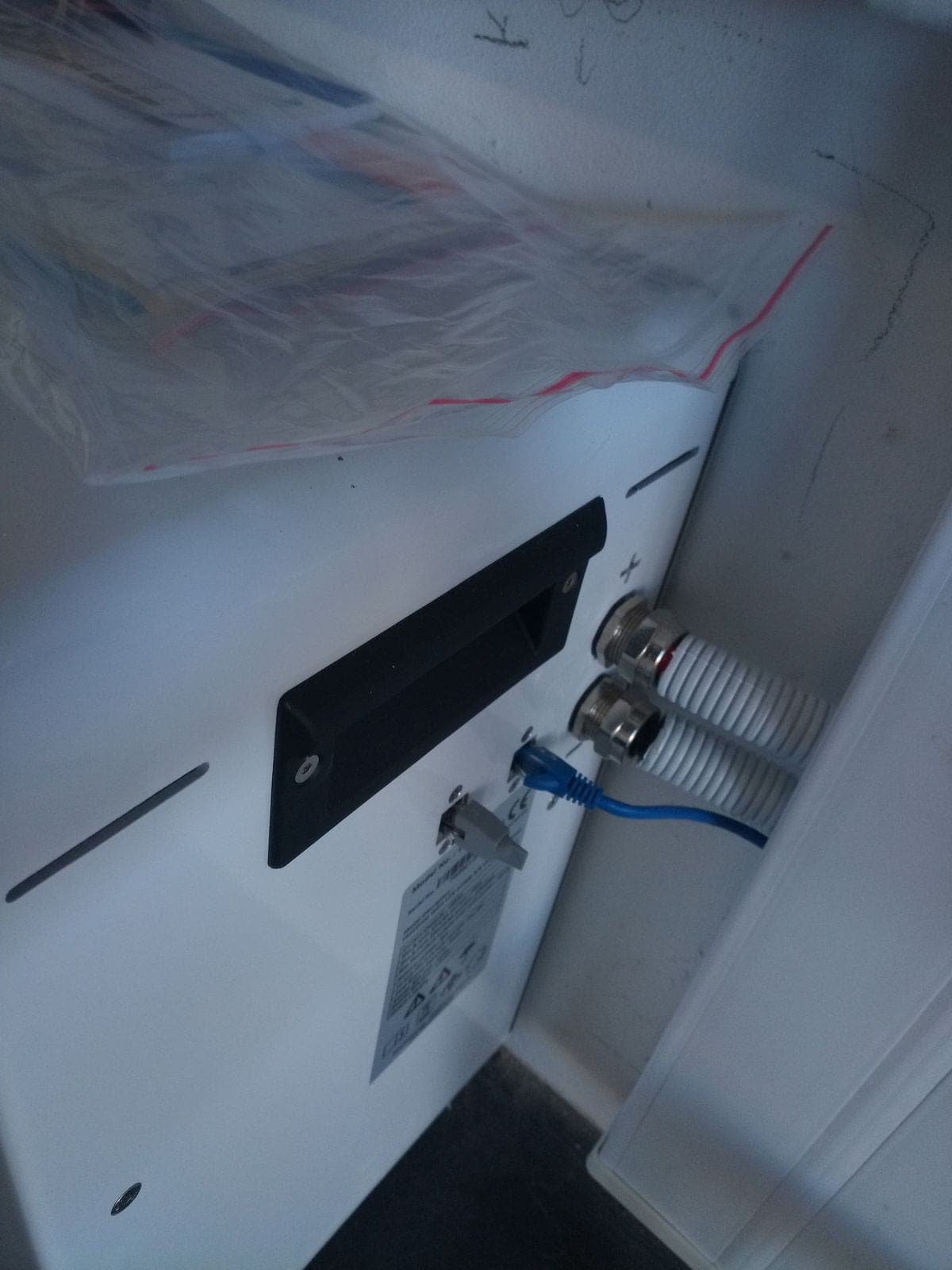 Battery cabling routed into the storage enclosure